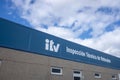 Ourense, Spain. 03-01-2023: ITV station center sign (Vehicle Technical Inspection) with a cloudy sky