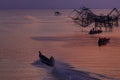 Ourists take a boat to see square dip net in the morning