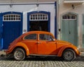 OURO PRETO, MINAS GERAIS, BRAZIL - DECEMBER 24, 2019: Orange retro car Volkswagen Beetle parked on the street in the ancient city