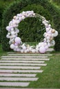 Ouside wedding ceremony. Balloon wedding arch in the garden.