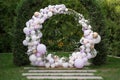 Ouside wedding ceremony. Balloon wedding arch in the garden