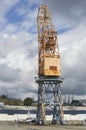 An out of Action yellow Port Crane stands Idly by as its being repaired in Brest Harbour.