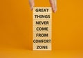 Out from comfort zone symbol. Wooden blocks with words Great things never come from comfort zone. Beautiful orange background,