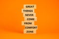 Out from comfort zone symbol. Wooden blocks with words Great things never come from comfort zone. Beautiful orange background,
