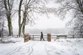 Single lone anonymous commuter walking to work during winter blizzard and heavy snowstorm wrapped up warm during icy storm