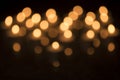 Out of focus arrangement of burning tea lights on a black background. 10 Royalty Free Stock Photo