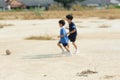 Out focus boy play football on dry soil ground Royalty Free Stock Photo
