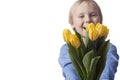 Out of focus boy presents yellow tulips