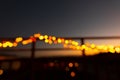 Out Of Focus Christmas Lights On The Railings Of A Balcony At Night..