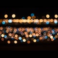 Out-of-focus image featuring colorful bokeh lights against a dark background. Warm