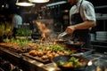 Out of focus professional chef preparing restaurant quality food in a professional kitchen, flame grilled, dynamic shallow depth