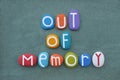 Out of memory, text composed with multi colored stone letters over green sand Royalty Free Stock Photo