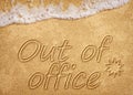 Out of office sign on beach sand Royalty Free Stock Photo