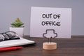 Out of office text on a paper note