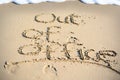 Out of office text written in sand on a beach Royalty Free Stock Photo