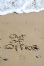 Out of office text written in sand on a beach Royalty Free Stock Photo