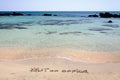 OUT OF OFFICE written on sand on a beautiful beach, blue waves in background Royalty Free Stock Photo