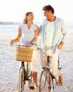 Out for a relaxing bike ride. A mature couple enjoying a bike ride on the beach together. Royalty Free Stock Photo