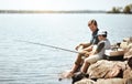 Out for some fishing fun in the sun. a father and his little son fishing together. Royalty Free Stock Photo