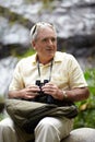 Out watching for birds. a senior man with binoculars looking at the scenery. Royalty Free Stock Photo