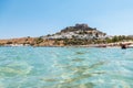 Out of the water view of Lindos village with ruins.