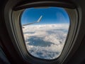 Out of the window of air plane and wing in the blue sky Royalty Free Stock Photo