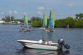 Outboard Motor Boat Sailing Catamarans and Paddle Boarders