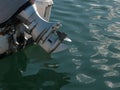 Outboard motor with propellor out of water, on the back of a small boat Royalty Free Stock Photo