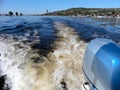 Outboard motor. Summer river landscape, photographed from the side of the boat. Russia, Saratov, the Volga river. Road bridge