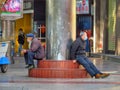 During the outbreak of the novel coronavirus (Wuhan pneumonia), two elderly people wore masks to cool in the square.