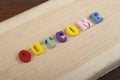 OUTCOME word on wooden background composed from colorful abc alphabet block wooden letters, copy space for ad text