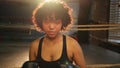 Outcry independent girl power. Angry african american woman fighter with boxing gloves looking serious aggressive to