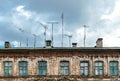 Obsolete rusty television antennas on the roof of an old house. Analog technology