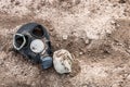 An outdated broken army gas mask is lying