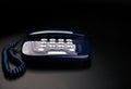 Outdated telephone with push buttons on black background Royalty Free Stock Photo