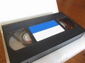 Outdated videocassette . Old video tape on wooden table Royalty Free Stock Photo