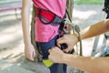 Child girl prepare for a bungee jump, put on safety belts Royalty Free Stock Photo