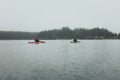 Unrecognized men in kayak. Summer trip on Ladoga lake in Karelia.