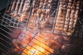 Outdoor activity: Top or aerial view of red hot flame roasting raw steaks of orange Salmon or melting fish on a bowl barbecue