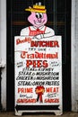 Outdoor advertising sign of British butcher promoting meat, steak, sausages, pies and pasties London