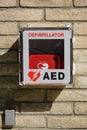 Outdoor AED cardiac defibrillator box isolated on brick background Royalty Free Stock Photo