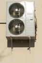 An outdoor air conditioner unit consisting of two fans. A large industrial air conditioner on the wall of a store or enterprise. Royalty Free Stock Photo