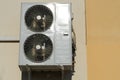 An outdoor air conditioner unit consisting of two fans. A large industrial air conditioner on the wall of a store or enterprise. Royalty Free Stock Photo