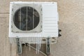 An outdoor air conditioner unit installed on the outer wall of a residential building close-up. Operation of the air conditioner Royalty Free Stock Photo