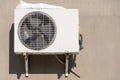 An outdoor air conditioner unit installed on the outer wall of a residential building. The fan and the radiator grille of the air Royalty Free Stock Photo