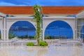 Outdoor seating in a restaurant in Budva with the view of the Old Town and the Adriatic Sea in Montenegro at sunset Royalty Free Stock Photo