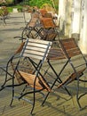 Outdoor alfresco dining chairs seats in stack row patio cafe restaurant