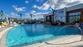 The outdoor amenities with a swimming pool, cabanas and lounge chairs at the Wave Hotel at Lake Nona in Orlando, Florida