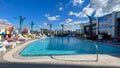 The outdoor amenities with a swimming pool, cabanas and lounge chairs at the Wave Hotel at Lake Nona in Orlando, Florida