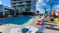 The outdoor amenities with a swimming pool, cabanas and lounge chairs at the Wave Hotel at Lake Nona in Orlando, Florida